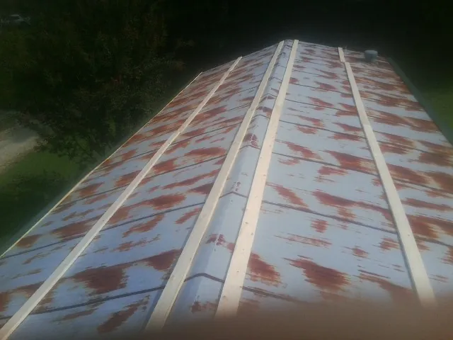 Rusted metal roof panels with new wood purlins before replacement — Storm Damage Roof Repair in Grapevine by Roofing Brothers